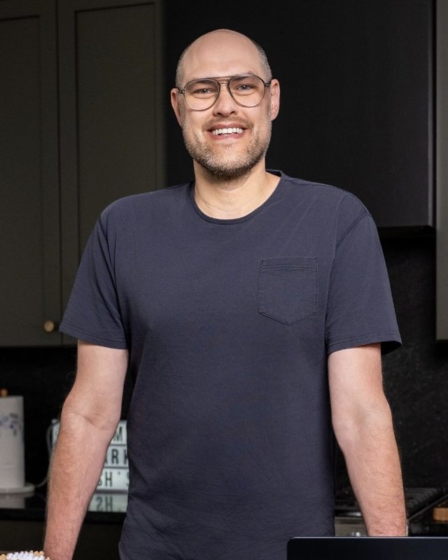Josh Driver, founder of The Huckleberry Co., smiling in a kitchen in Indianapolis